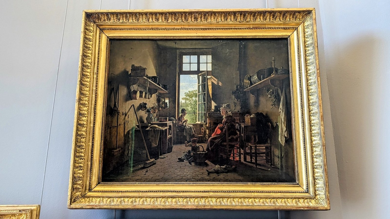 The painting 'L'intérieur d'une cuisine' by Martin Drölling hanging in the Louvre.